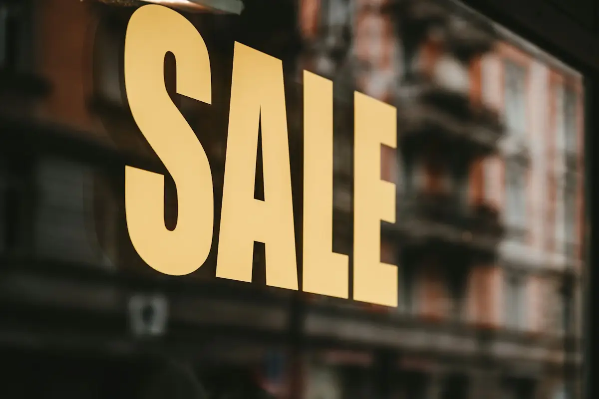 HAULS Journal photo of yellow SALE lettering on a shop window