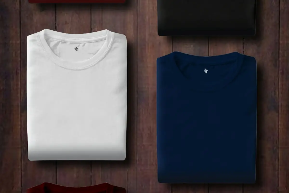 HAULS Journal photo of neatly folded white, black and navy t-shirts on a wooden surface