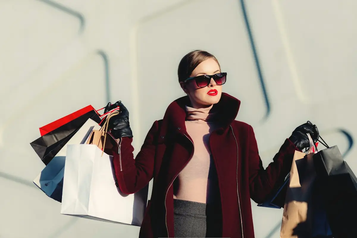 HAULS Journal photo of a woman in sunglasses holding several shopping bags