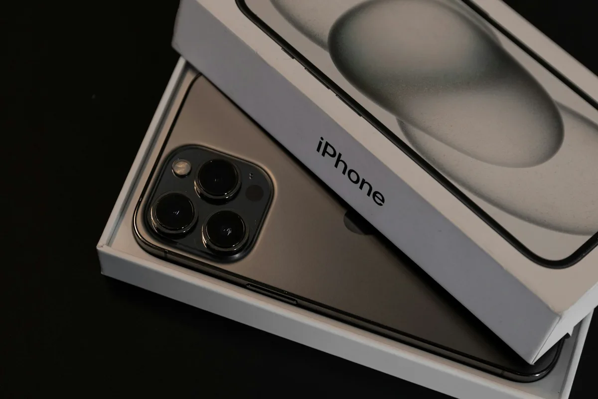HAULS Journal photo of a new smartphone resting in its open white retail box on a dark tabletop